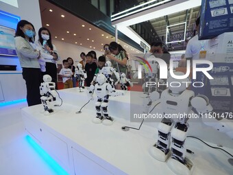 Visitors visit a ''wise teaching robot'' at the 2024 World Robot Conference in Beijing, China, on August 22, 2024. (