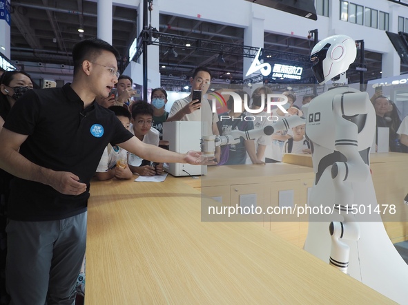 Visitors interact with a home service robot at the 2024 World Robot Conference in Beijing, China, on August 22, 2024. 