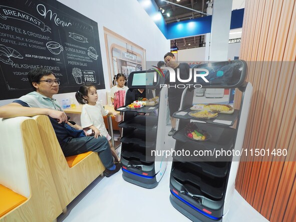 Visitors visit a ''food delivery robot'' at the 2024 World Robot Conference in Beijing, China, on August 22, 2024. 