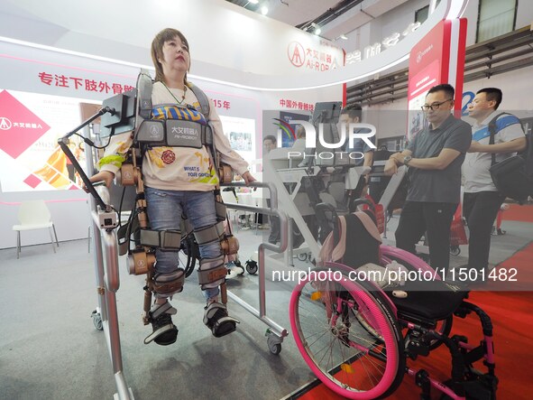 Visitors experience a ''lower limb exoskeleton robot'' at the 2024 World Robot Conference in Beijing, China, on August 22, 2024. 