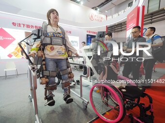 Visitors experience a ''lower limb exoskeleton robot'' at the 2024 World Robot Conference in Beijing, China, on August 22, 2024. (