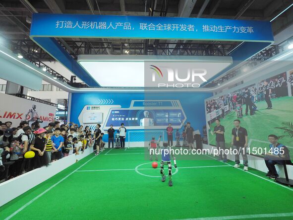 Spectators watch ''robot football'' at the 2024 World Robot Conference in Beijing, China, on August 22, 2024. 