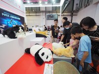 Visitors view a bionic robot at the 2024 World Robot Conference in Beijing, China, on August 22, 2024. (