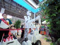 Visitors visit an ''intelligent humanoid picking robot'' at the 2024 World Robot Conference in Beijing, China, on August 22, 2024. (