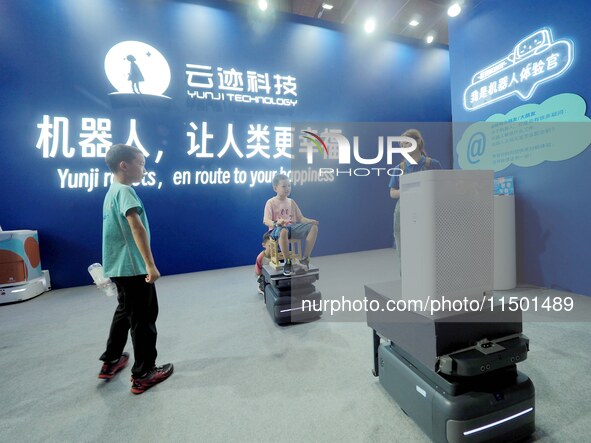 Visitors experience the ''UP robot'' at the 2024 World Robot Conference in Beijing, China, on August 22, 2024. 