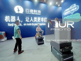 Visitors experience the ''UP robot'' at the 2024 World Robot Conference in Beijing, China, on August 22, 2024. (