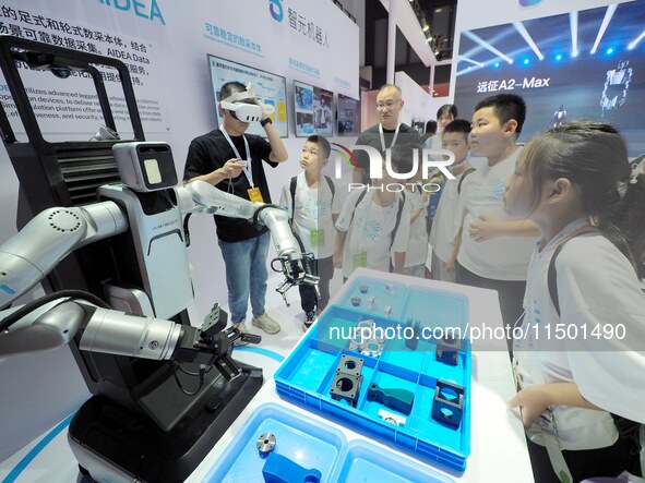 Visitors view a ''flexible intelligent robot'' at the 2024 World Robot Conference in Beijing, China, on August 22, 2024. 