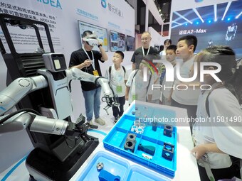 Visitors view a ''flexible intelligent robot'' at the 2024 World Robot Conference in Beijing, China, on August 22, 2024. (