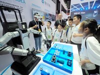 Visitors view a ''flexible intelligent robot'' at the 2024 World Robot Conference in Beijing, China, on August 22, 2024. (