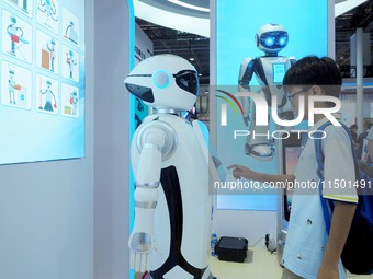 Visitors experience a ''domestic service robot'' at the 2024 World Robot Conference in Beijing, China, on August 22, 2024. (