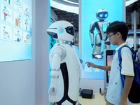 Visitors experience a ''domestic service robot'' at the 2024 World Robot Conference in Beijing, China, on August 22, 2024. (