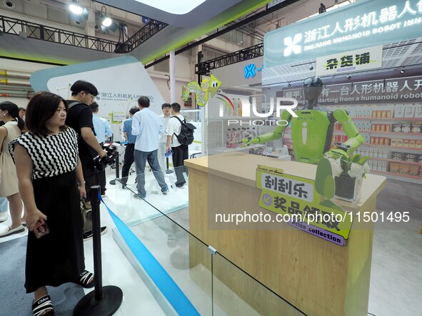 Visitors view a ''vending robot'' at the 2024 World Robot Conference in Beijing, China, on August 22, 2024. 