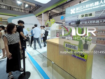 Visitors view a ''vending robot'' at the 2024 World Robot Conference in Beijing, China, on August 22, 2024. (