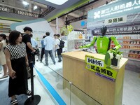 Visitors view a ''vending robot'' at the 2024 World Robot Conference in Beijing, China, on August 22, 2024. (