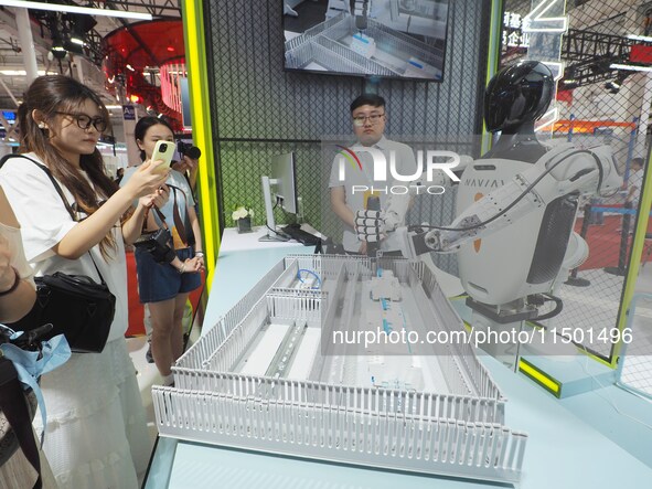 Visitors view ''industrial robots'' at the 2024 World Robot Conference in Beijing, China, on August 22, 2024. 