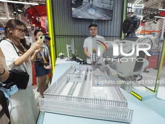 Visitors view ''industrial robots'' at the 2024 World Robot Conference in Beijing, China, on August 22, 2024. (