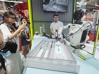 Visitors view ''industrial robots'' at the 2024 World Robot Conference in Beijing, China, on August 22, 2024. (