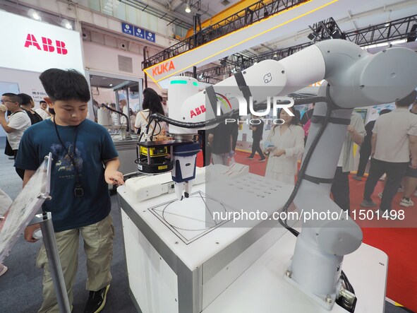 Visitors visit an ''educational robot'' at the 2024 World Robot Conference in Beijing, China, on August 22, 2024. 