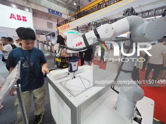 Visitors visit an ''educational robot'' at the 2024 World Robot Conference in Beijing, China, on August 22, 2024. (