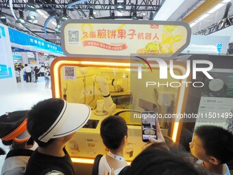 Visitors view a ''Jianbing robot'' at the 2024 World Robot Conference in Beijing, China, on August 22, 2024. (