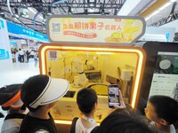 Visitors view a ''Jianbing robot'' at the 2024 World Robot Conference in Beijing, China, on August 22, 2024. (