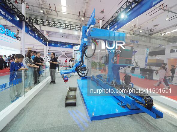 Visitors visit the ''Robot Untaught Welding System'' at the 2024 World Robot Conference in Beijing, China, on August 22, 2024. 