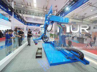 Visitors visit the ''Robot Untaught Welding System'' at the 2024 World Robot Conference in Beijing, China, on August 22, 2024. (