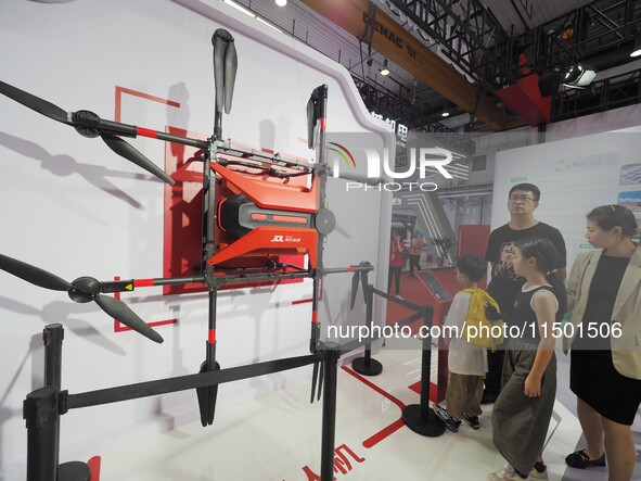 Visitors visit a ''JD.com Logistics delivery drone'' at the 2024 World Robot Conference in Beijing, China, on August 22, 2024. 