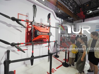 Visitors visit a ''JD.com Logistics delivery drone'' at the 2024 World Robot Conference in Beijing, China, on August 22, 2024. (