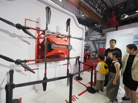 Visitors visit a ''JD.com Logistics delivery drone'' at the 2024 World Robot Conference in Beijing, China, on August 22, 2024. (