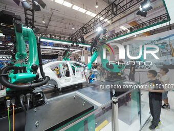 Visitors visit the ''four-machine spot Welding Exhibition station'' at the 2024 World Robot Conference in Beijing, China, on August 22, 2024...