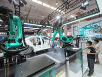 Visitors visit the ''four-machine spot Welding Exhibition station'' at the 2024 World Robot Conference in Beijing, China, on August 22, 2024...