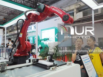 Visitors visit the ''Industrial robot 3D Visual gluing workstation'' at the 2024 World Robot Conference in Beijing, China, on August 22, 202...