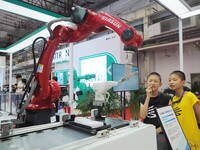 Visitors visit the ''Industrial robot 3D Visual gluing workstation'' at the 2024 World Robot Conference in Beijing, China, on August 22, 202...