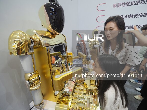 Visitors experience a ''cosmetic robot'' at the 2024 World Robot Conference in Beijing, China, on August 22, 2024. 