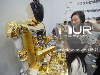 Visitors experience a ''cosmetic robot'' at the 2024 World Robot Conference in Beijing, China, on August 22, 2024. (