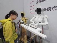 Visitors visit a ''piano robot'' at the 2024 World Robot Conference in Beijing, China, on August 22, 2024. (