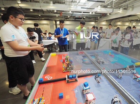 Young players compete at the 2024 World Robot Competition in Beijing, China, on August 22, 2024. 