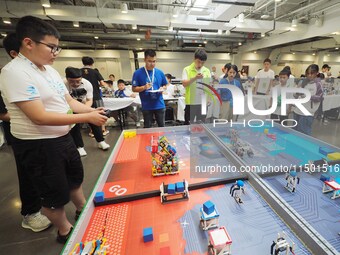 Young players compete at the 2024 World Robot Competition in Beijing, China, on August 22, 2024. (