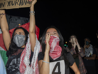 Protesters chant while joining a pro-Palestinian demonstration at George Washington University in Washington, D.C., on August 22, 2024. Duri...