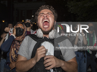 Protesters chant while joining a pro-Palestinian demonstration at George Washington University in Washington, D.C., on August 22, 2024. Duri...