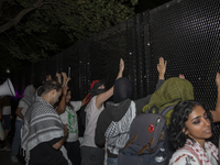 Protesters try to break the security fence at George Washington University in Washington, D.C., on August 22, 2024, while joining a pro-Pale...