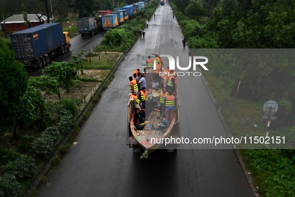 Volunteers carry a boat on a truck to help flood-affected people in Comilla, Bangladesh, on August 23, 2024. 