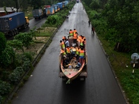 Volunteers carry a boat on a truck to help flood-affected people in Comilla, Bangladesh, on August 23, 2024. (