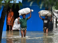 Local residents shift to temporary shelter homes as floodwater rises in their homes in Feni, Chittagong, Bangladesh, on August 23, 2024. (