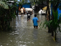 Local residents shift to temporary shelter homes as floodwater rises in their homes in Feni, Chittagong, Bangladesh, on August 23, 2024. (