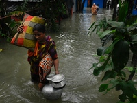 Local residents shift to temporary shelter homes as floodwater rises in their homes in Feni, Chittagong, Bangladesh, on August 23, 2024. (