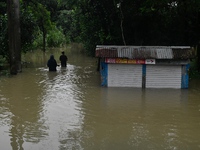 People wade through floodwater in Feni, Chittagong, Bangladesh, on August 23, 2024. (