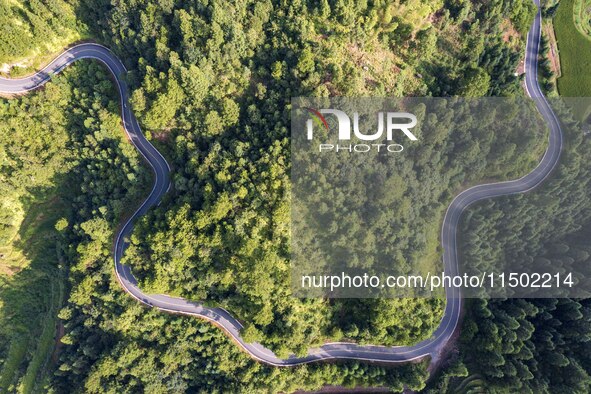 An aerial photo shows a rural road in Baidao village, Congjiang county, in Congjiang, China, on August 22, 2024. 