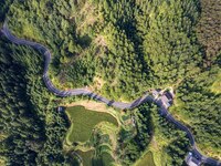 An aerial photo shows a rural road in Baidao village, Congjiang county, in Congjiang, China, on August 22, 2024. (